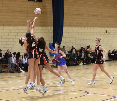 Hucclecote GK and GD contesting for the ball against Oldham