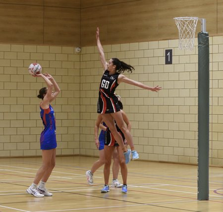 Hucclecote GD leaping to defend a shot by Oldham